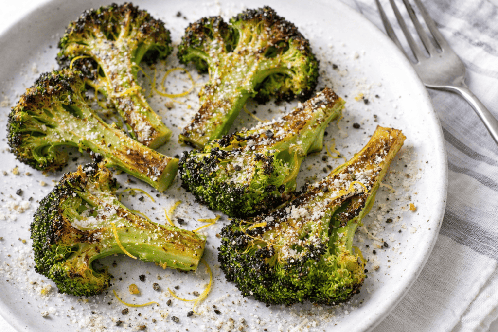 Healthy roasted broccoli topped with Parmesan and lemon zest.