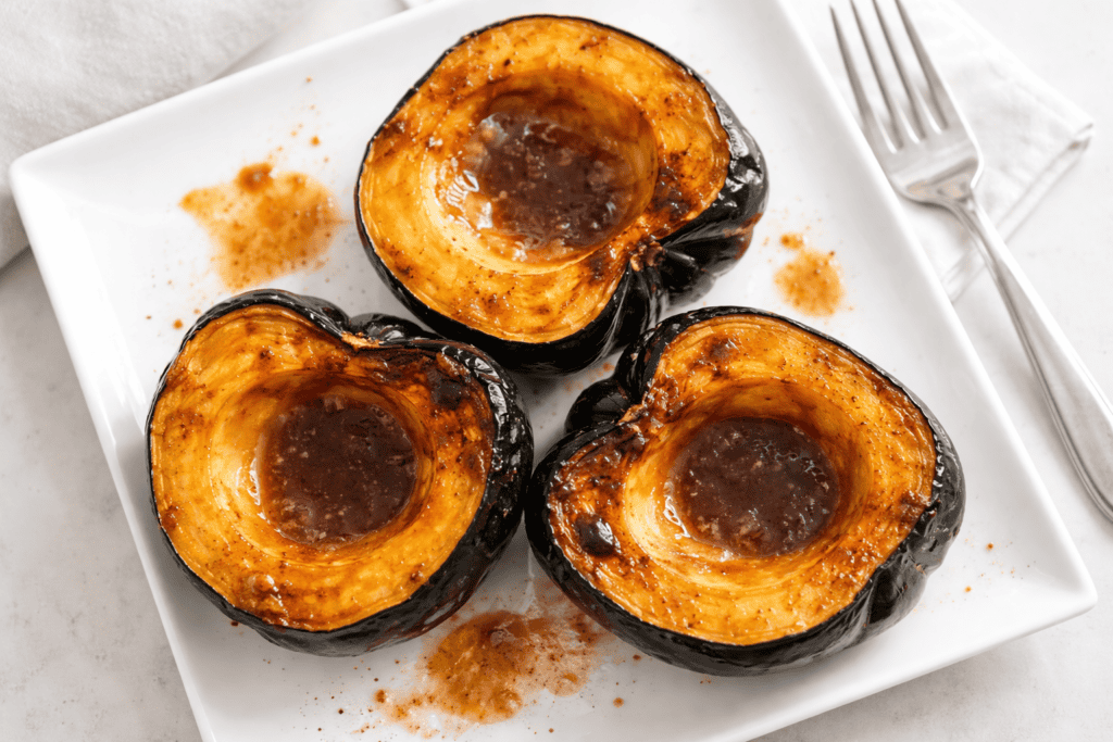 Eggplant halves grilled to perfection with a savory sauce, served on a white plate.
