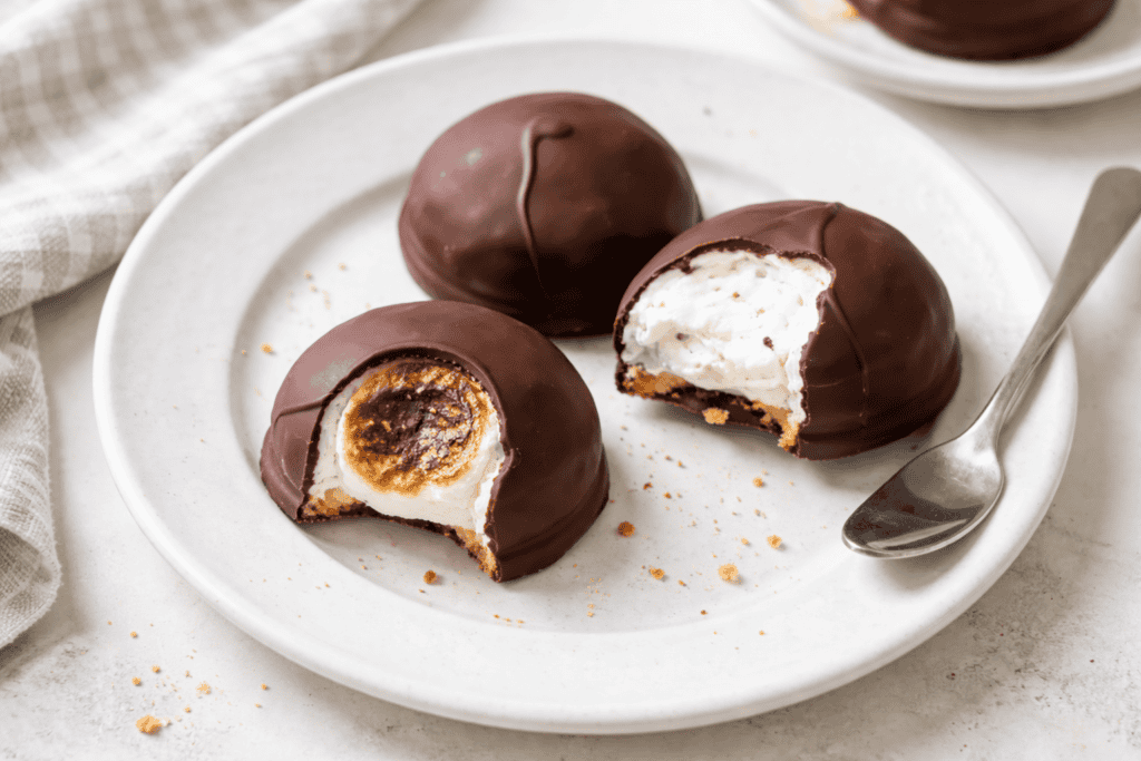 Delicious chocolate-coated cookies with gooey marshmallow filling, perfect for sweet cravings and de.