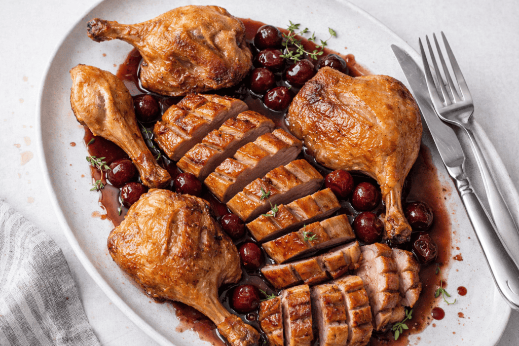 Delicious roasted duck with crispy skin served with a rich cherry sauce and fresh herbs. Perfect for.
